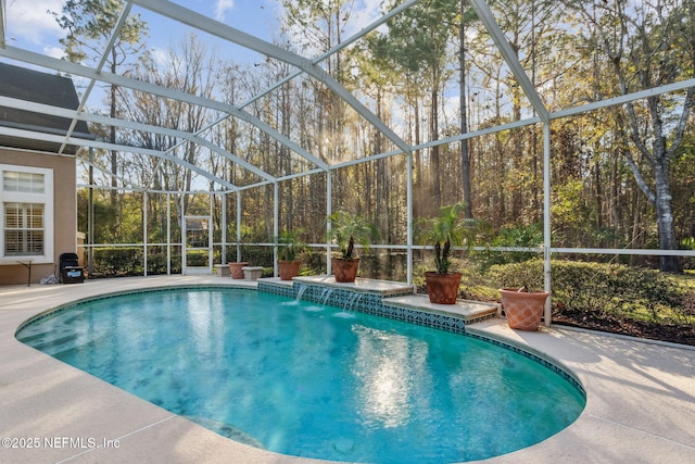 view of pool featuring a lanai, pool water feature, and a patio