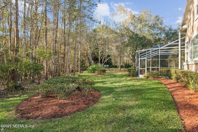 view of yard with glass enclosure