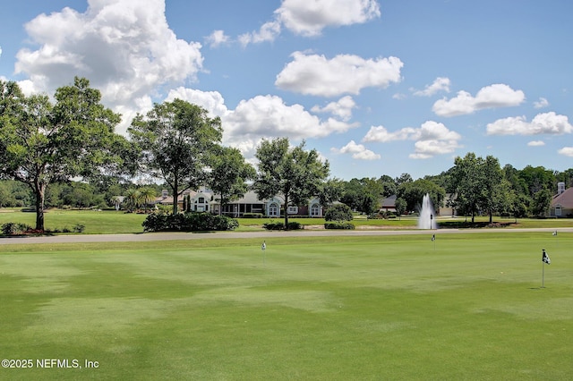 view of property's community with a lawn