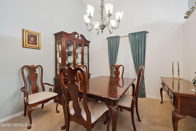 carpeted dining area featuring a chandelier