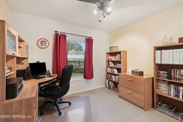 carpeted office space with a textured ceiling