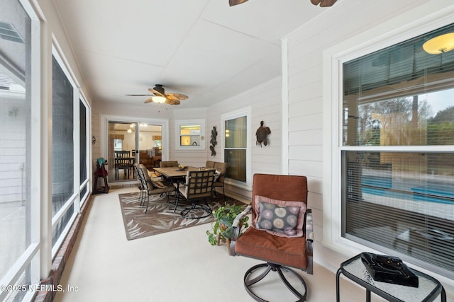 sunroom / solarium featuring ceiling fan