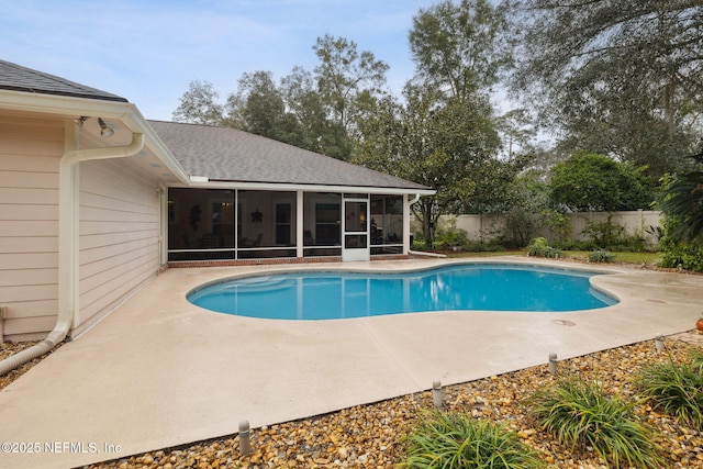 view of swimming pool with a sunroom and a patio