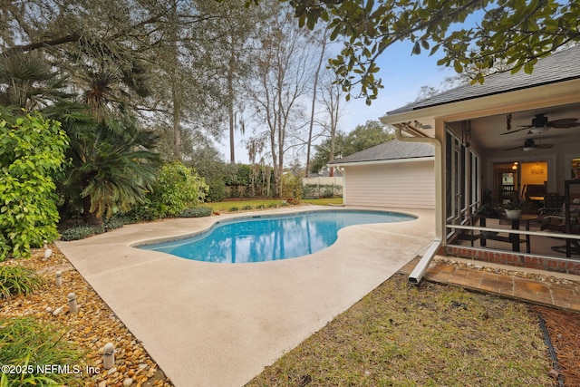 view of swimming pool featuring ceiling fan, a sunroom, and a patio