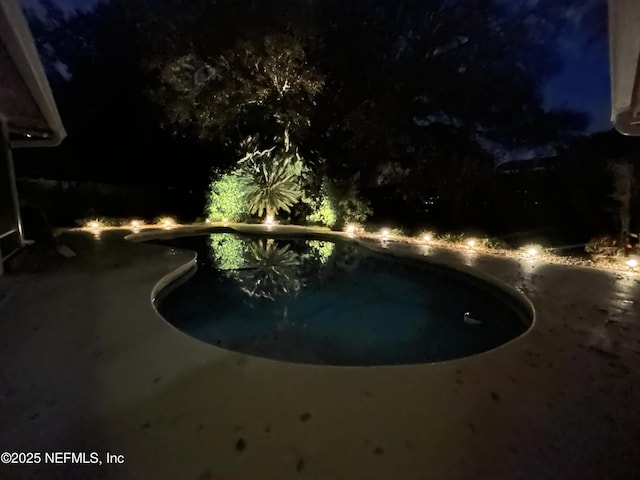 view of pool at night