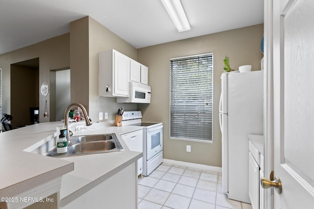 kitchen with sink, white cabinets, light tile patterned flooring, and white appliances