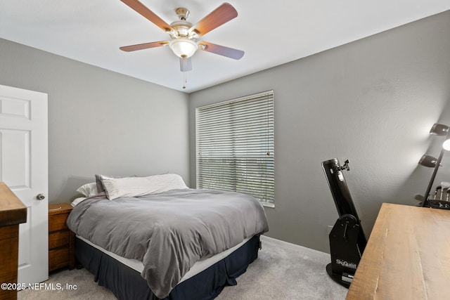 bedroom featuring ceiling fan and light carpet