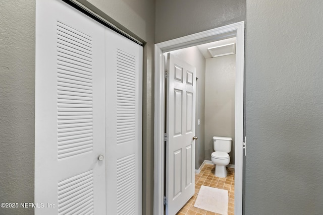 bathroom with tile patterned flooring and toilet