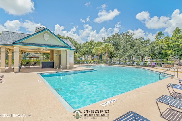 view of swimming pool featuring ceiling fan and a patio area