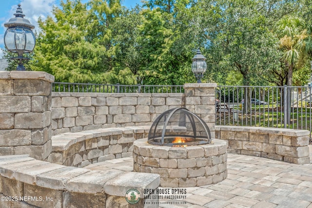 exterior details featuring an outdoor fire pit