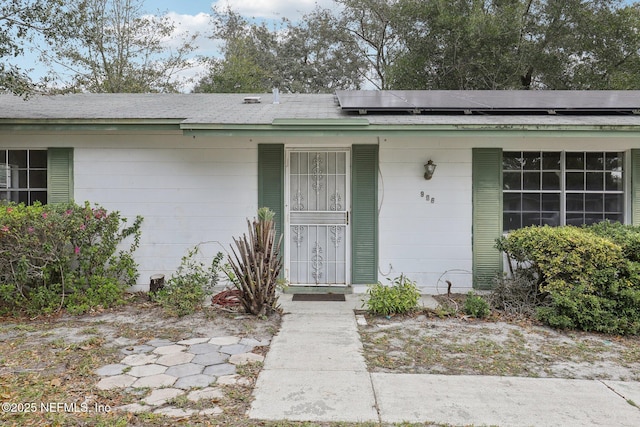 view of exterior entry with solar panels