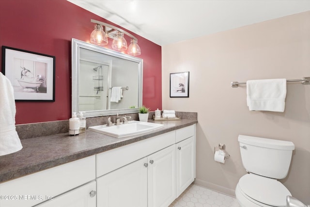 bathroom featuring tile patterned flooring, vanity, and toilet