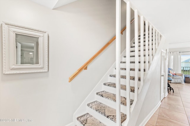 staircase with tile patterned floors