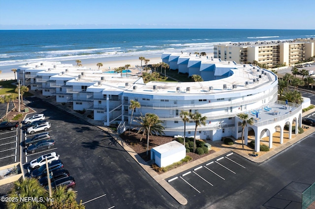 bird's eye view with a water view and a view of the beach