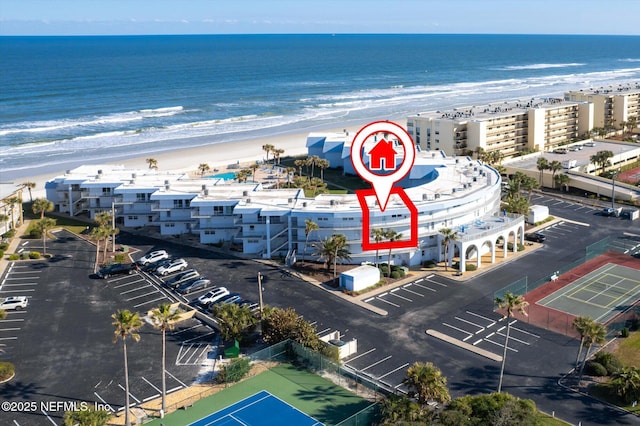 drone / aerial view with a beach view and a water view