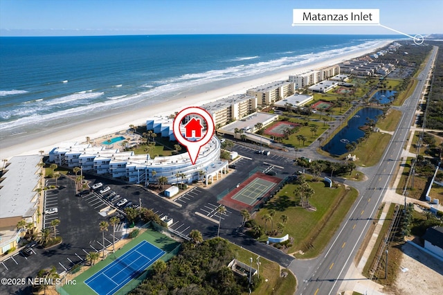 drone / aerial view featuring a water view and a view of the beach