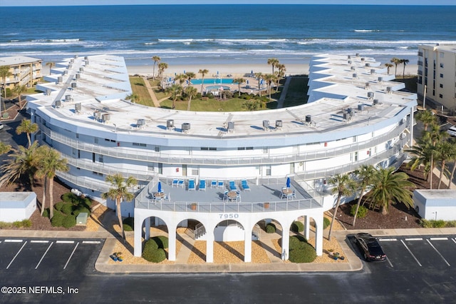 bird's eye view featuring a water view and a beach view