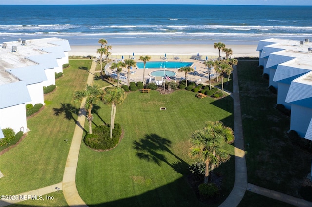 birds eye view of property featuring a water view and a view of the beach