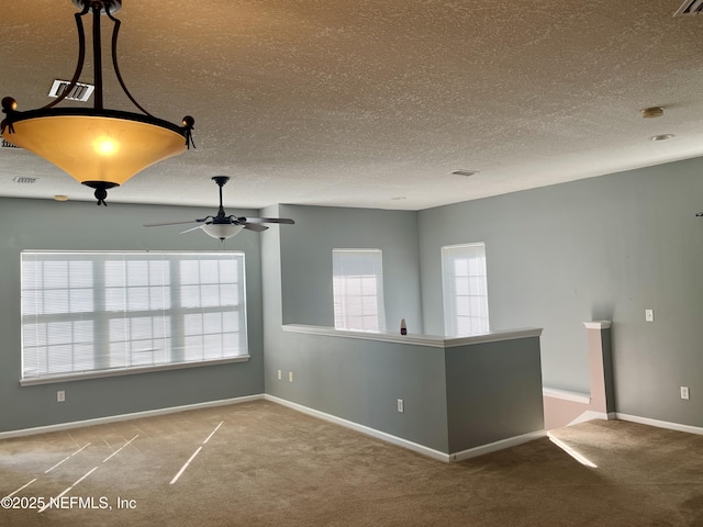 carpeted spare room with ceiling fan