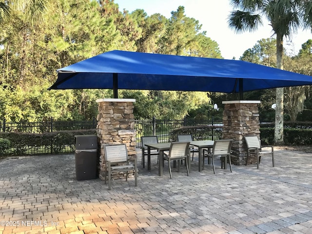 view of patio / terrace featuring an outdoor stone fireplace