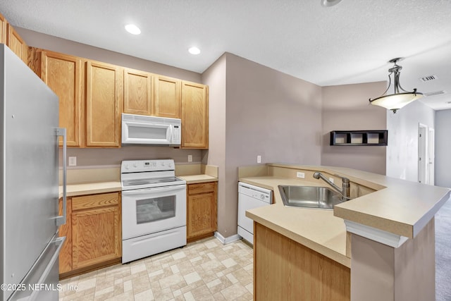 kitchen featuring kitchen peninsula, white appliances, hanging light fixtures, and sink