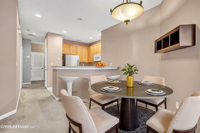 dining room featuring light colored carpet