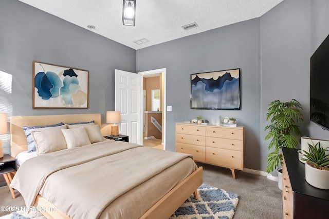 bedroom featuring carpet flooring and a textured ceiling