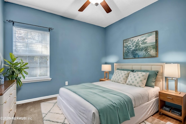 bedroom featuring ceiling fan and light colored carpet