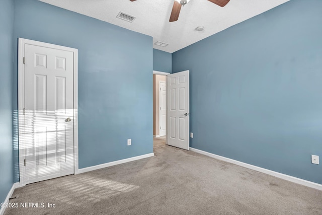 spare room with carpet floors and ceiling fan