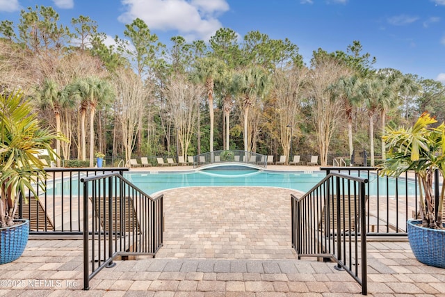 view of swimming pool featuring a patio area