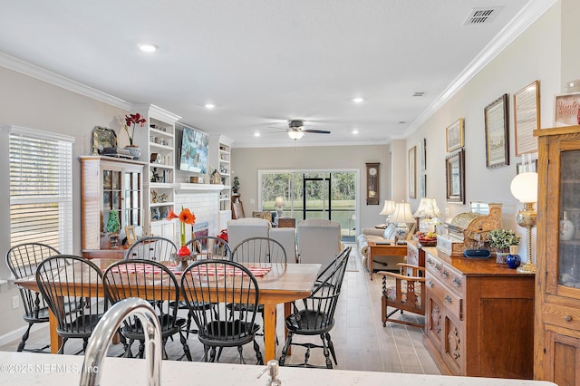 dining area featuring ceiling fan, light hardwood / wood-style floors, plenty of natural light, and ornamental molding