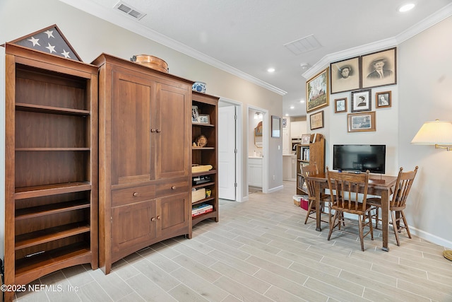 home office with light wood-type flooring and ornamental molding