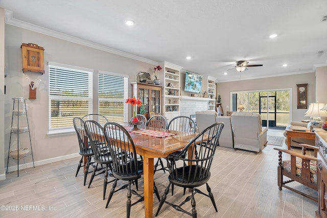 dining space with crown molding, ceiling fan, and a healthy amount of sunlight