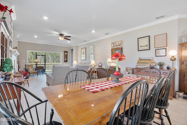 dining room with ceiling fan and ornamental molding