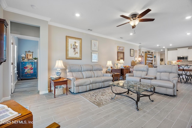 living room with ceiling fan and crown molding