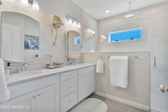 bathroom featuring tile patterned flooring, vanity, and a shower with shower door