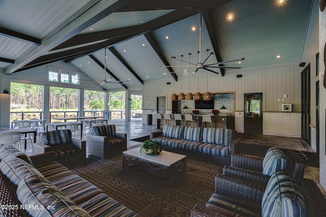 living room featuring a wealth of natural light, beamed ceiling, high vaulted ceiling, and ceiling fan