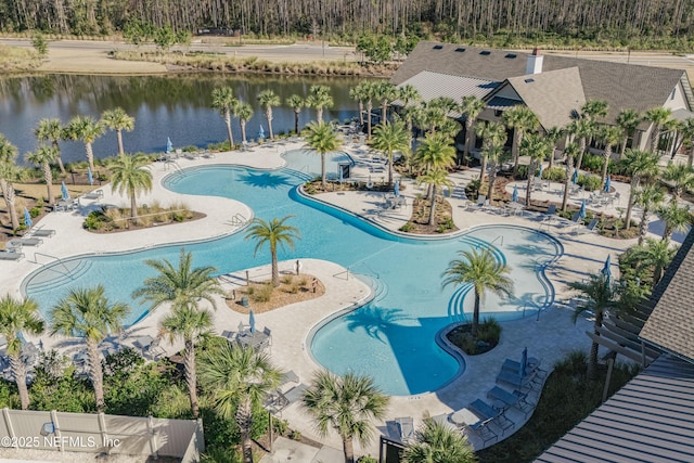 view of swimming pool with a water view and a patio area