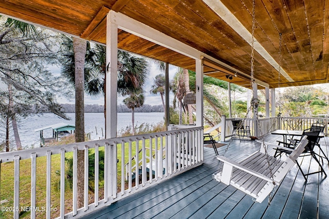 wooden deck featuring a yard and a water view