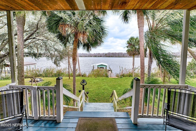 exterior space with a lawn and a water view