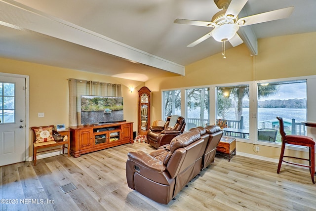 living room with lofted ceiling with beams, light hardwood / wood-style floors, and ceiling fan