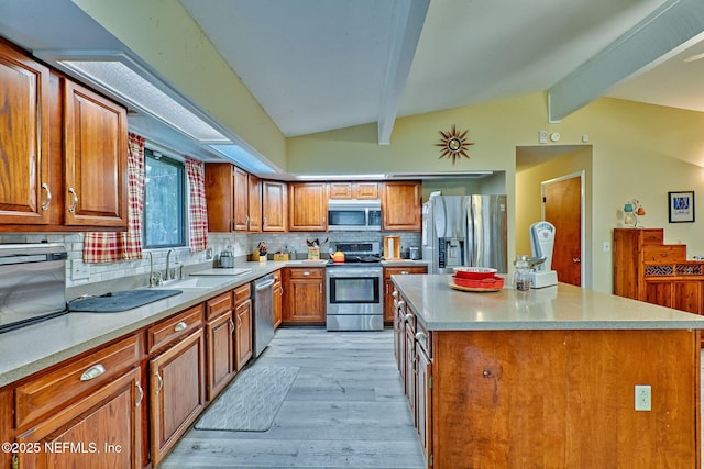 kitchen with a center island, sink, stainless steel appliances, tasteful backsplash, and vaulted ceiling with beams