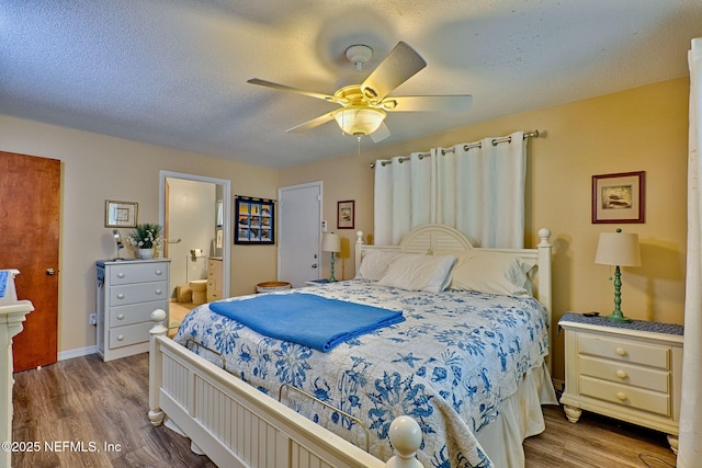 bedroom featuring hardwood / wood-style flooring, ceiling fan, a textured ceiling, and connected bathroom