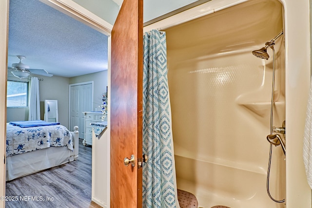 bathroom with a shower with curtain, a textured ceiling, ceiling fan, and hardwood / wood-style floors