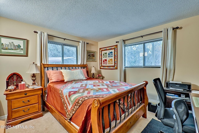 bedroom with a textured ceiling and multiple windows