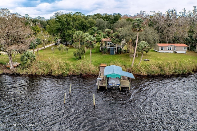 dock area with a yard and a water view