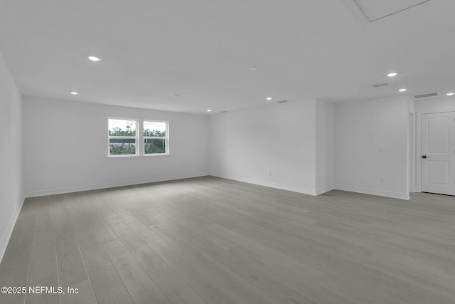 empty room featuring recessed lighting, visible vents, baseboards, and wood finished floors