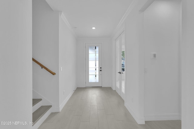 doorway to outside with stairway, baseboards, light wood-style floors, and crown molding