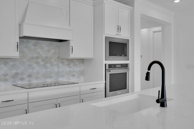 kitchen featuring backsplash, appliances with stainless steel finishes, crown molding, and custom range hood