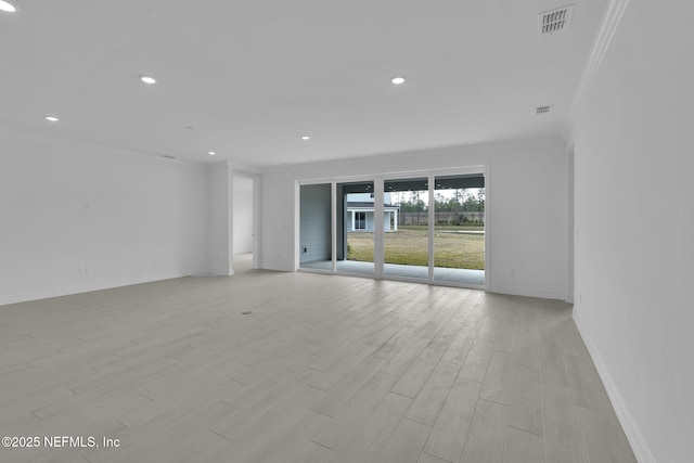 spare room featuring visible vents, recessed lighting, crown molding, light wood finished floors, and baseboards